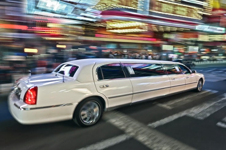 image is showing white Limousine on the street