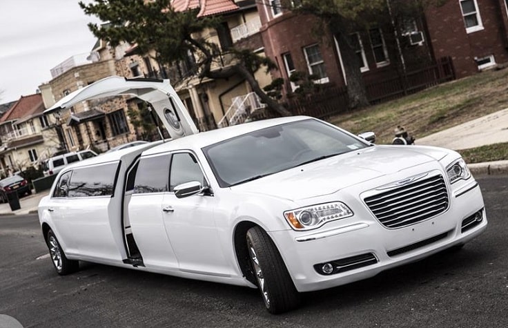 image is showing white Chrysler limo with open door