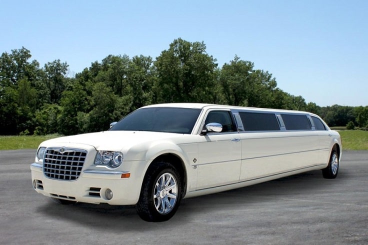 image is showing white Limousine on the road