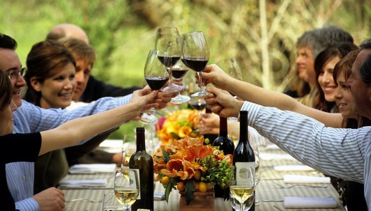 image is showing people with glasses in napa wineries during limo tours