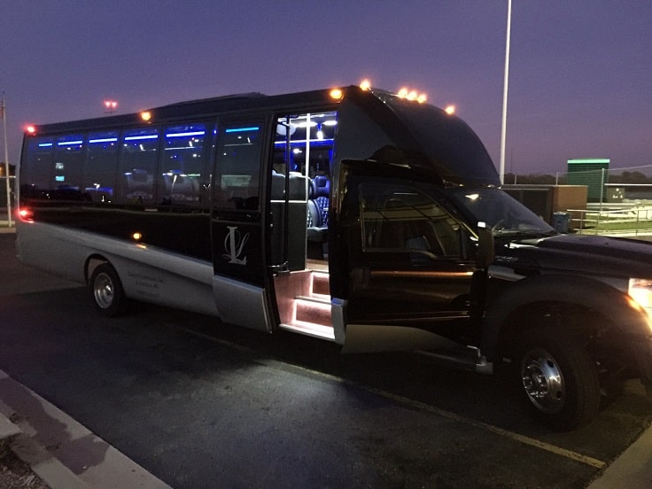 image of black party bus with light at night time